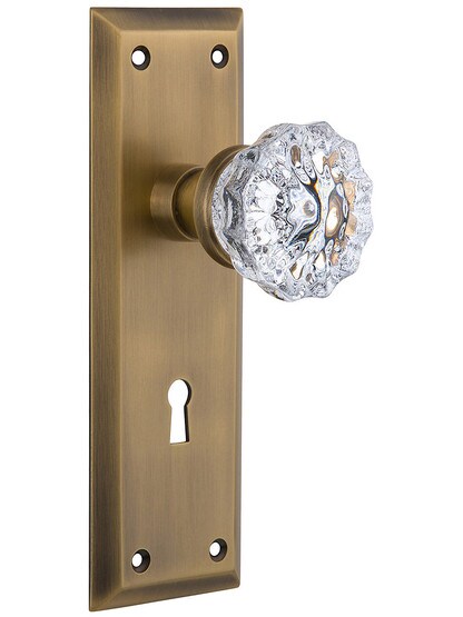 New York Mortise Lock Set With Fluted Crystal Door Knobs in Antique Brass.